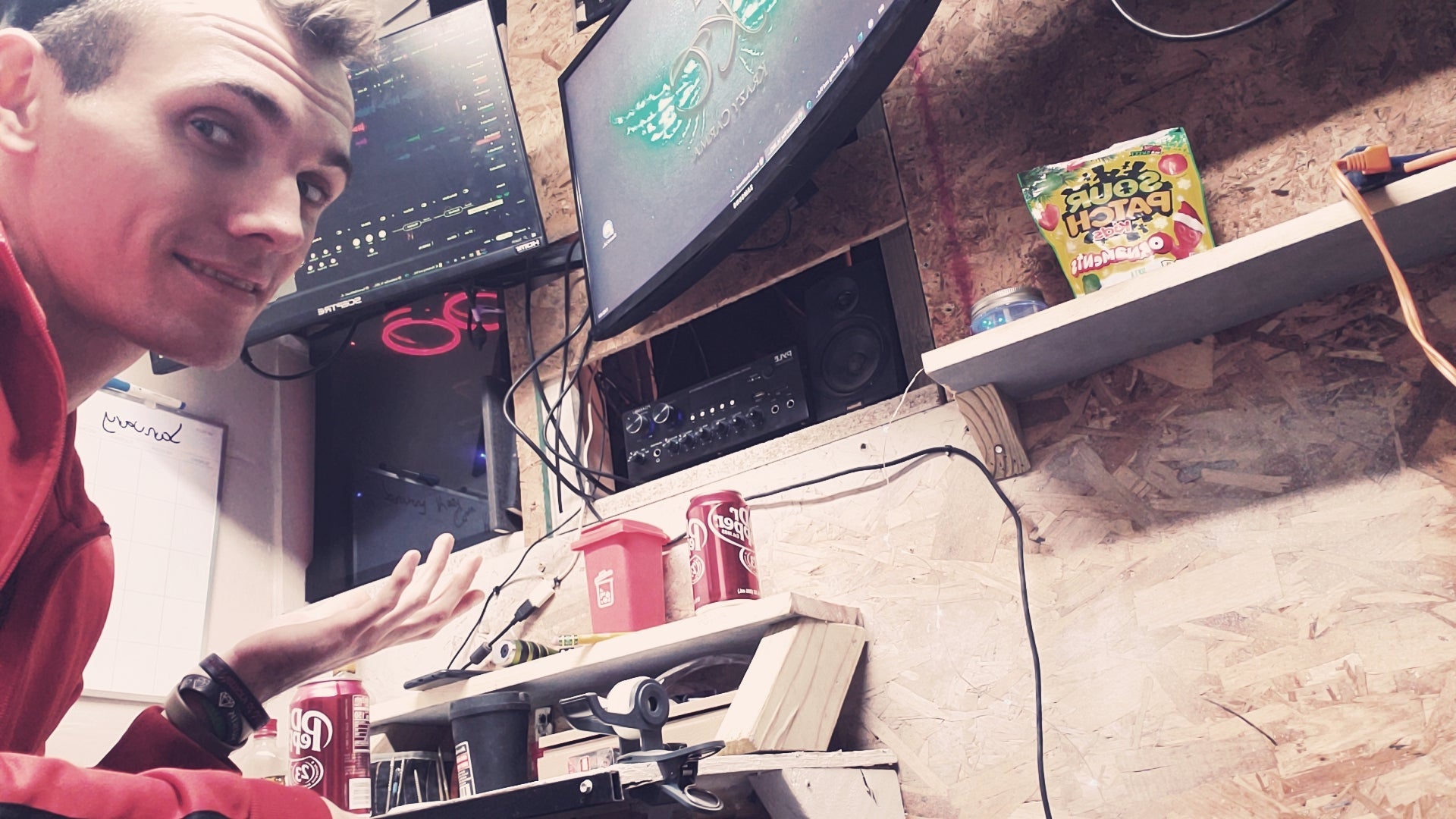 Person using a computer in a studio with snacks and a audio project in the background