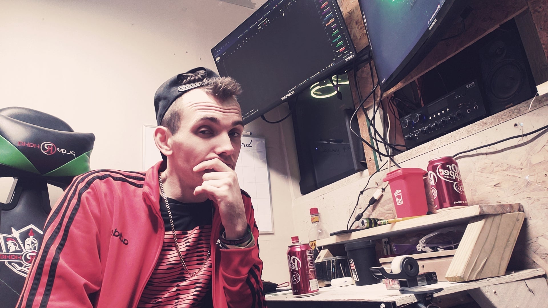 Krazy Carma sitting at a desk with computer equipment and snacks.